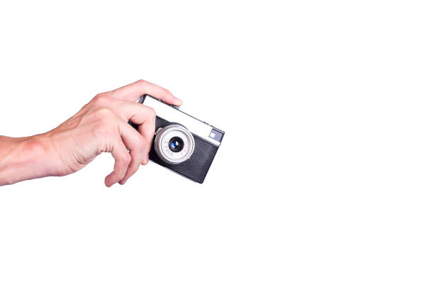 istock Hand with vintage camera on white background 926398478
