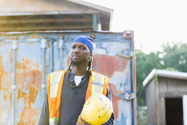 istock Worker standing in front of old semi-truck trailer 926398638