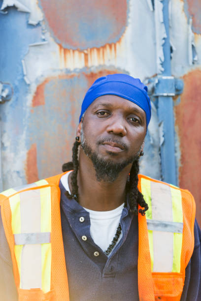 istock Worker standing in front of old semi-truck trailer 926398752