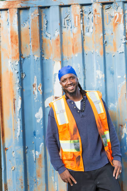 istock Worker standing in front of old semi-truck trailer 926398762