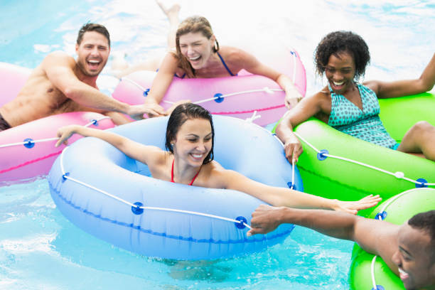 istock Multi-ethnic group of friends on inflatable rings 926403526