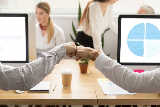 istock Colleagues giving fist bump, corporate teamwork concept, close up view 926404208