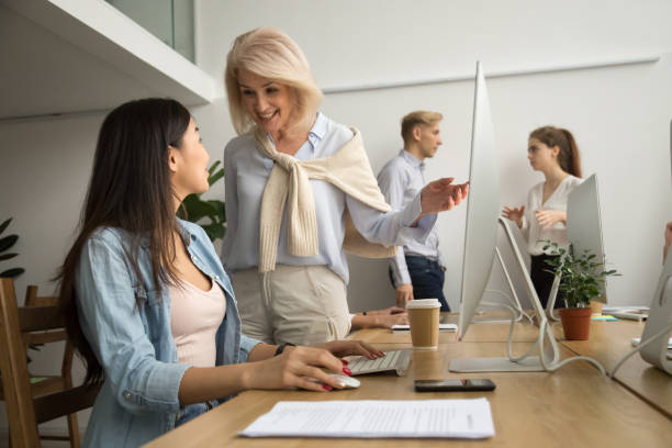 istock Smiling happy senior executive talking to asian employee at workplace 926404304