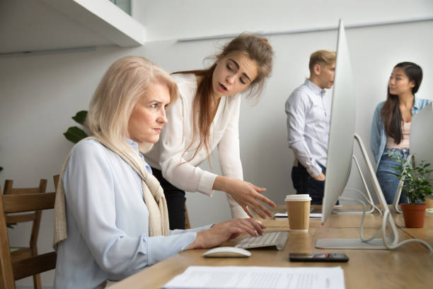 Young team leader correcting offended senior employee scolding for mistake