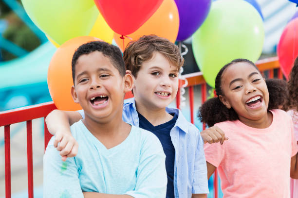 istock Multi-ethnic children laughing, colorful balloons 926404976