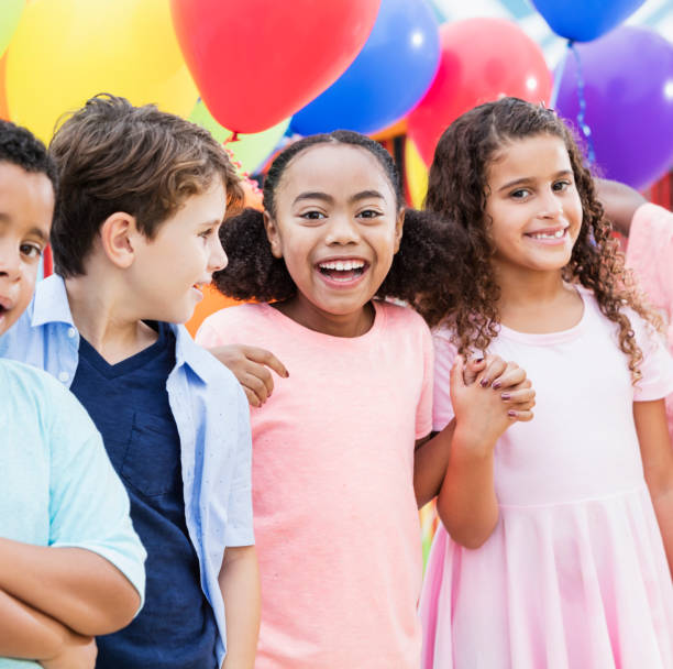 istock Multi-ethnic children laughing, colorful balloons 926404980