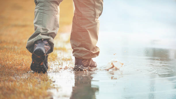Hiking boots walking in mud ground