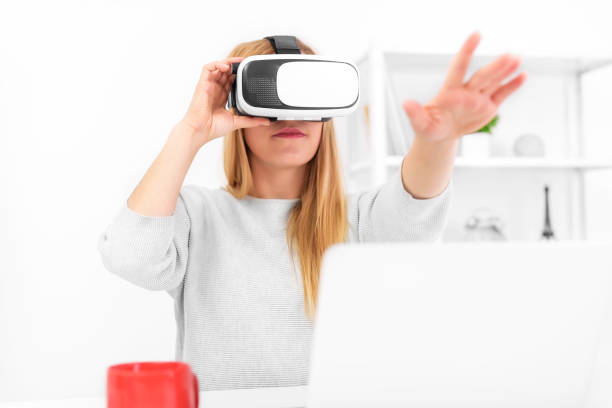istock Beautiful young woman playing game in virtual reality glasses 926411434