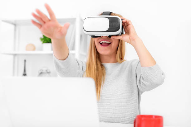 istock Beautiful young woman playing game in virtual reality glasses 926411450