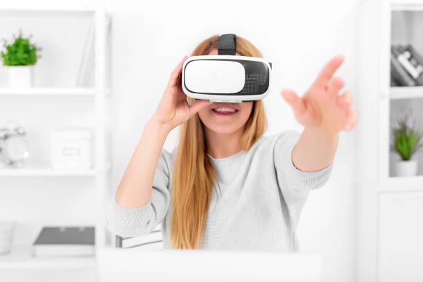 istock Beautiful young woman playing game in virtual reality glasses 926411514