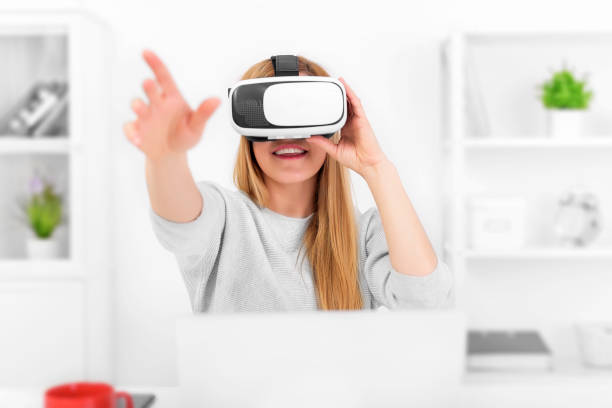 istock Beautiful young woman playing game in virtual reality glasses 926411536