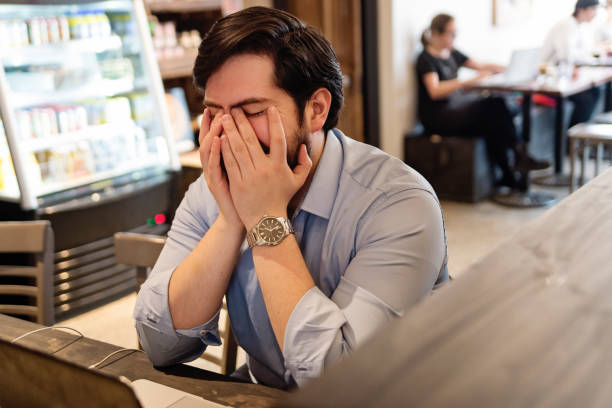 istock Tired man working on portable computer in a local coffee shop. 926412166