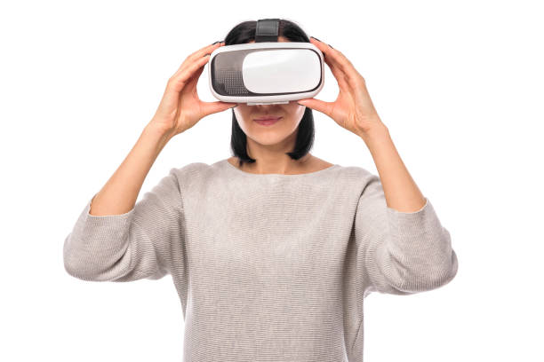 istock Young woman in a virtual reality helmet on a white 926415906