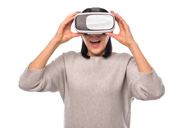istock Young woman in a virtual reality helmet on a white 926415920