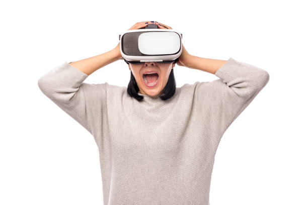 istock Young woman in a virtual reality helmet on a white 926415922