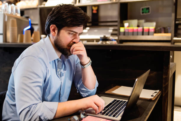 istock Man working on portable computer in a local coffee shop. 926416120