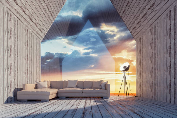 Minimalist interior with large cylindrical columns framing a sweeping view of a rugged mountain landscape; Living room with smooth beige textures, modern sofa and decorative ceramics. Interior and decor. 3d render.
