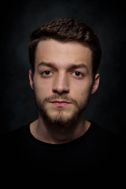 istock Portrait of a young man with a beard on a dark background 926420526