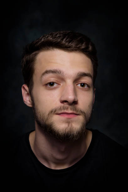 istock Portrait of a young man with a beard on a dark background 926420570