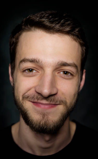 istock Portrait of a young man with a beard on a dark background 926420682