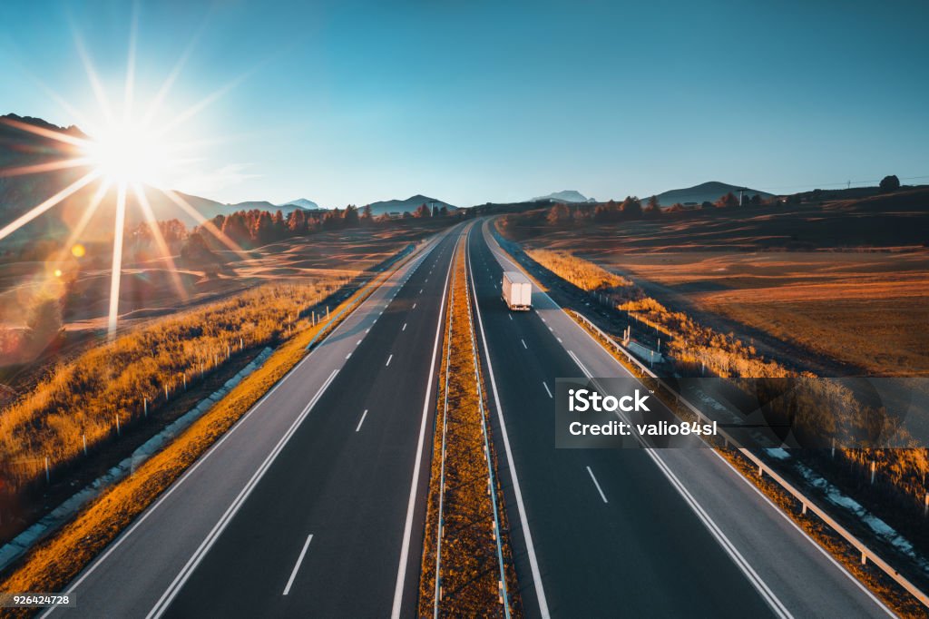 Driving on open road at beautiful sunny day. Aerial view of highway. Truck Stock Photo