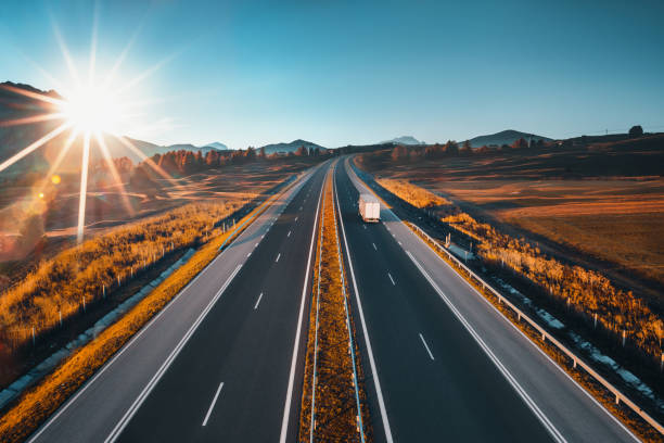 Driving on open road at beautiful sunny day. Aerial view of highway. Driving on open road at beautiful sunny day. Aerial view of highway. interstate photos stock pictures, royalty-free photos & images