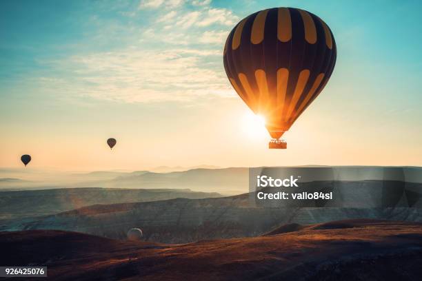 Hot Air Balloons Flying Over The Valley At Cappadocia Turkey Stock Photo - Download Image Now