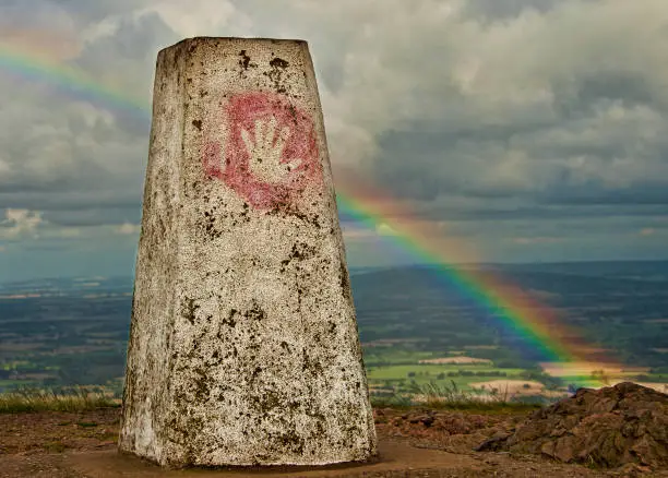 Trig point and rainbow on the Malvern Hills Worcestershire