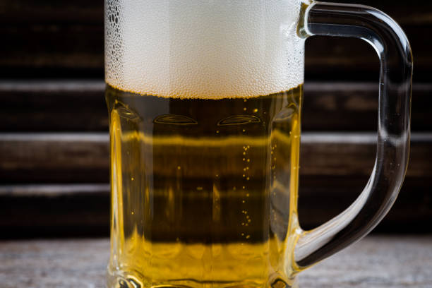 mug of beer on wooden background