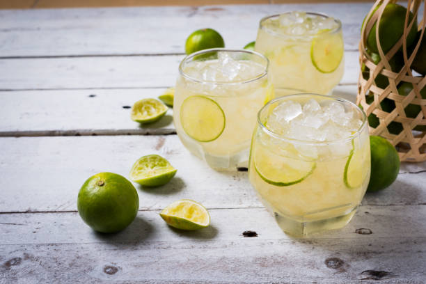 istock Cocktail with ice and lime slice on old wood table 926436140