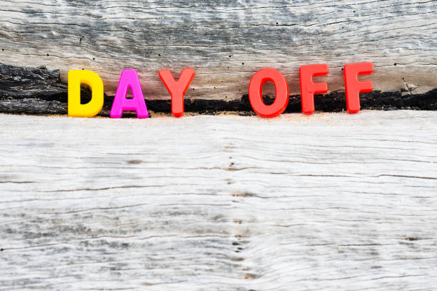 "DAY OFF" words on wood background stock photo