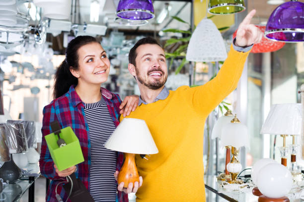 istock Guy and girl making a purchase of a lamp 926445364