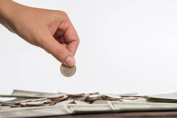 istock Woman hand puts a coin in stacked. 926451468