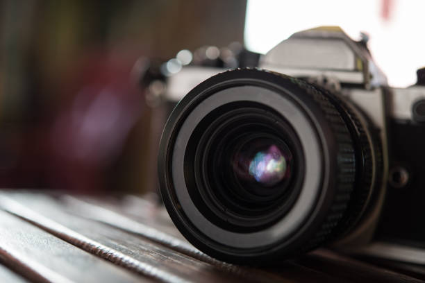 istock Vintage film camera on wooden table. Retro style. 926457834