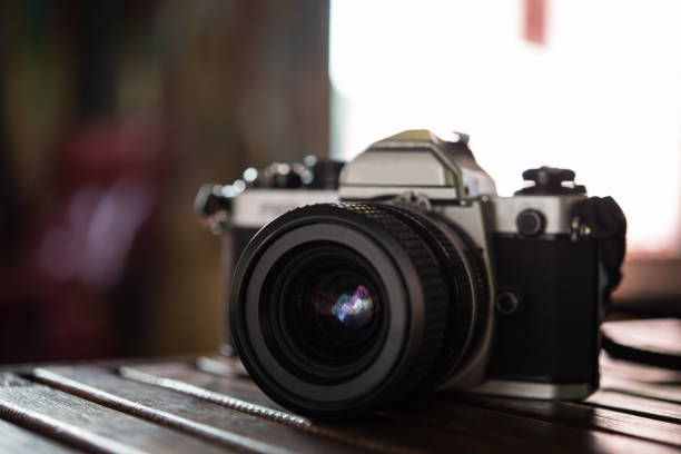 istock Vintage film camera on wooden table. Retro style. 926457844