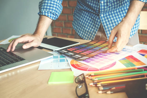 Graphic designer drawing on graphics tablet at workplace Graphic designer drawing on graphics tablet at workplace graphic design studio stock pictures, royalty-free photos & images