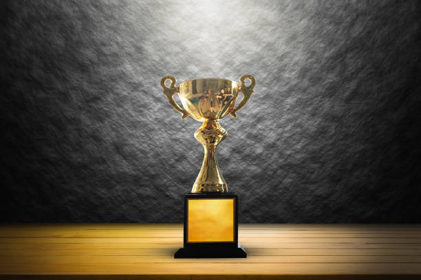 istock Champion golden trophy on wooden table background. copy space. 926464528