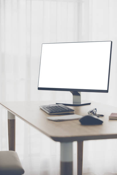Workspace background with desktop pc and office accessories on table,White screen on monitor. stock photo