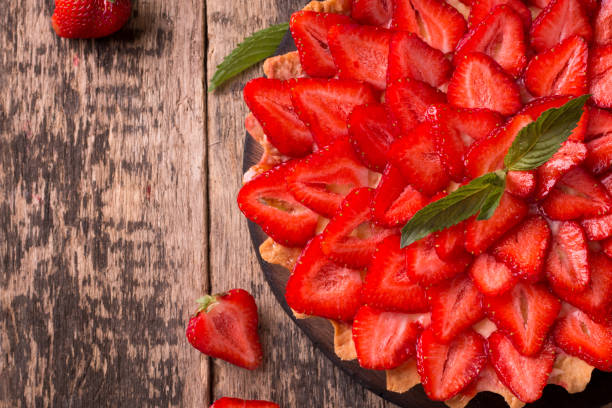 istock Tart with strawberries and whipped cream on wooden background 926472012