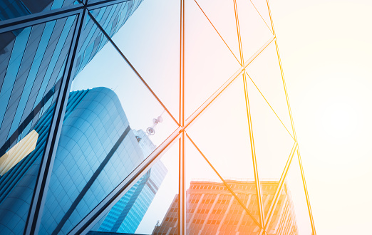 Reflections of modern commercial buildings on glasses