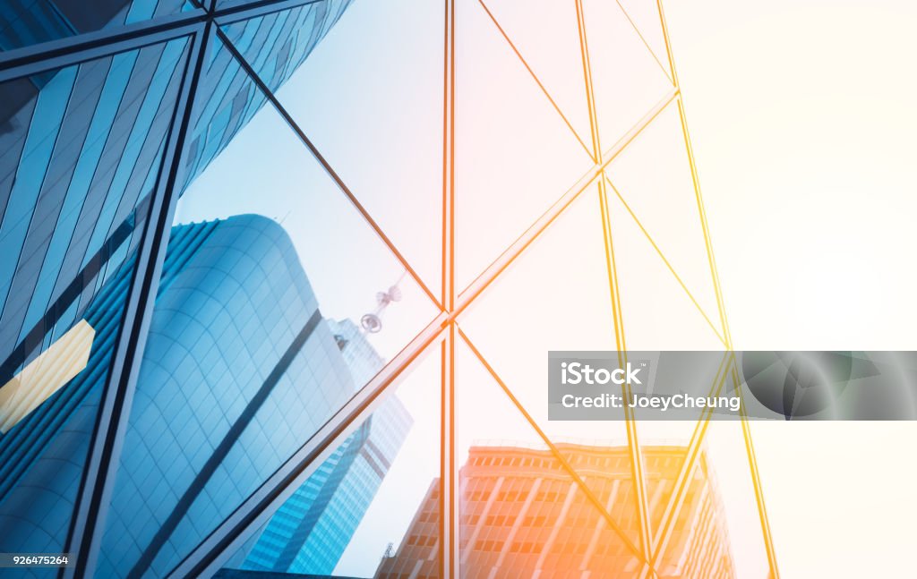 Reflections of modern commercial buildings on glasses with sunlight Reflections of modern commercial buildings on glasses Construction Industry Stock Photo