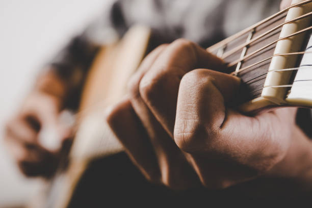 istock Close up of man hand playing guitar. 926478898