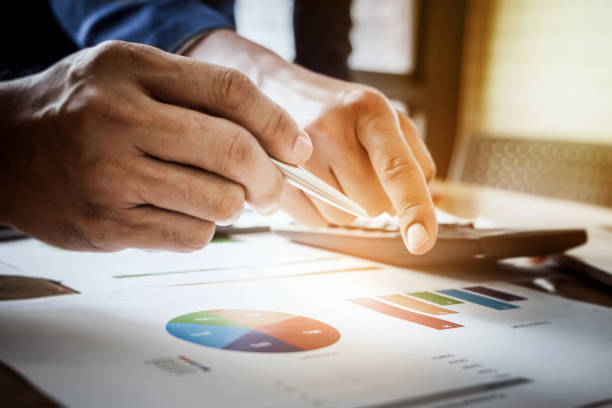 istock Young business man pointing graph chart with partner   for analyze, plan, improve, improve their marketing. 926479146