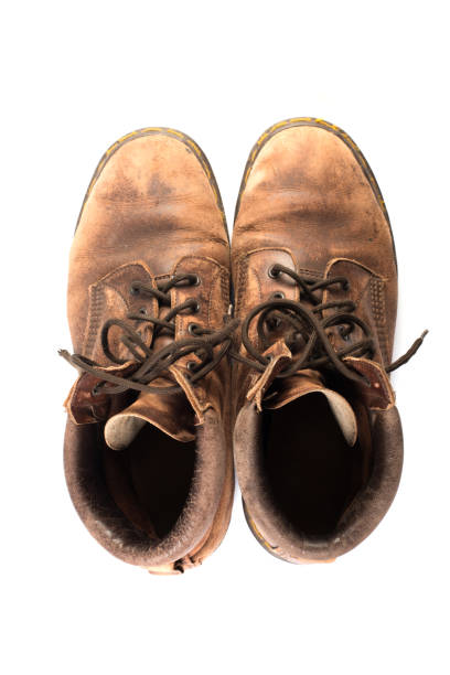 istock Pair of old brown working boots Isolated on white background. 926486352