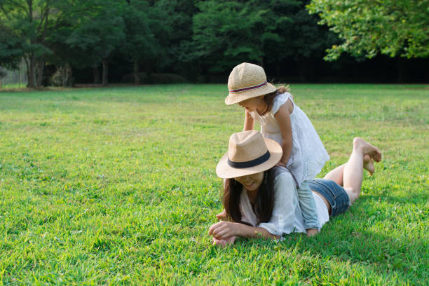 istock Mother and daughter playing on the lawn 926486576