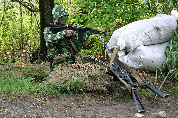 istock Ambush: soldier in camouflage uniform with Kalashnikov 92648702