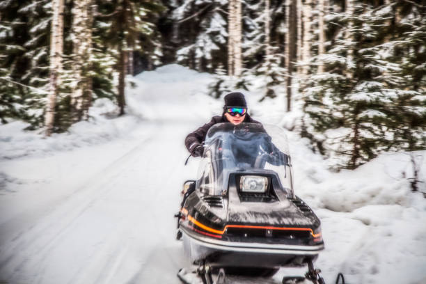istock A man is riding a snowmobile in the winter forest 926490502