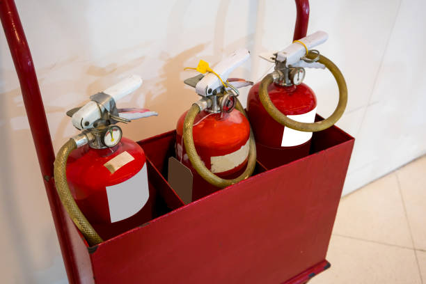 istock Red fire extinguishers in the red metal cart 926491068