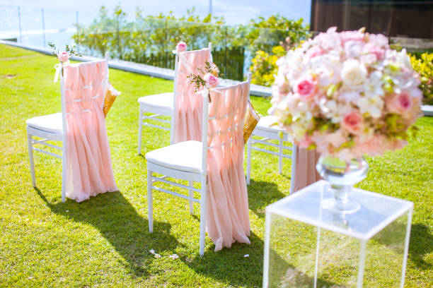 istock Wedding chair decorated with flowers on the lawn. 926494992