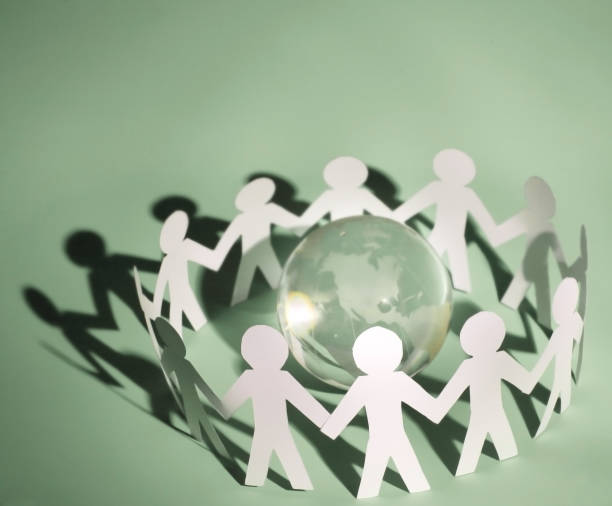 istock group of paper men standing around the glass globe 926498626